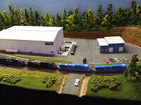 Quad Locos Haul Their Train Past Norfolk and Southern Workshops on Kentucky Division